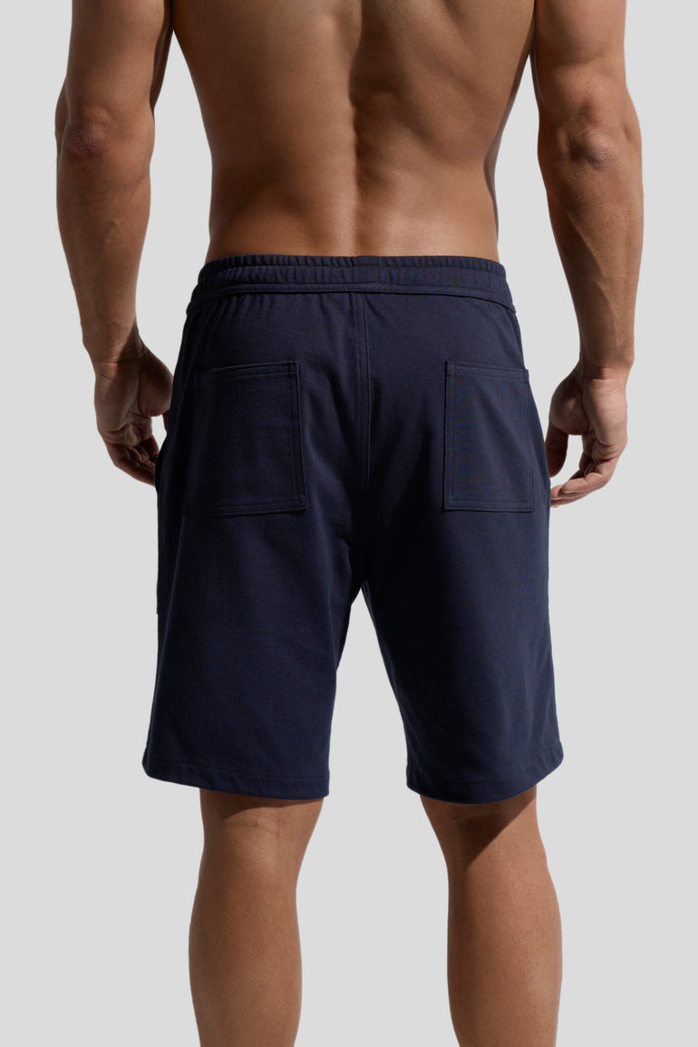 image of navy organic cotton shorts worn by model back view by bas bains