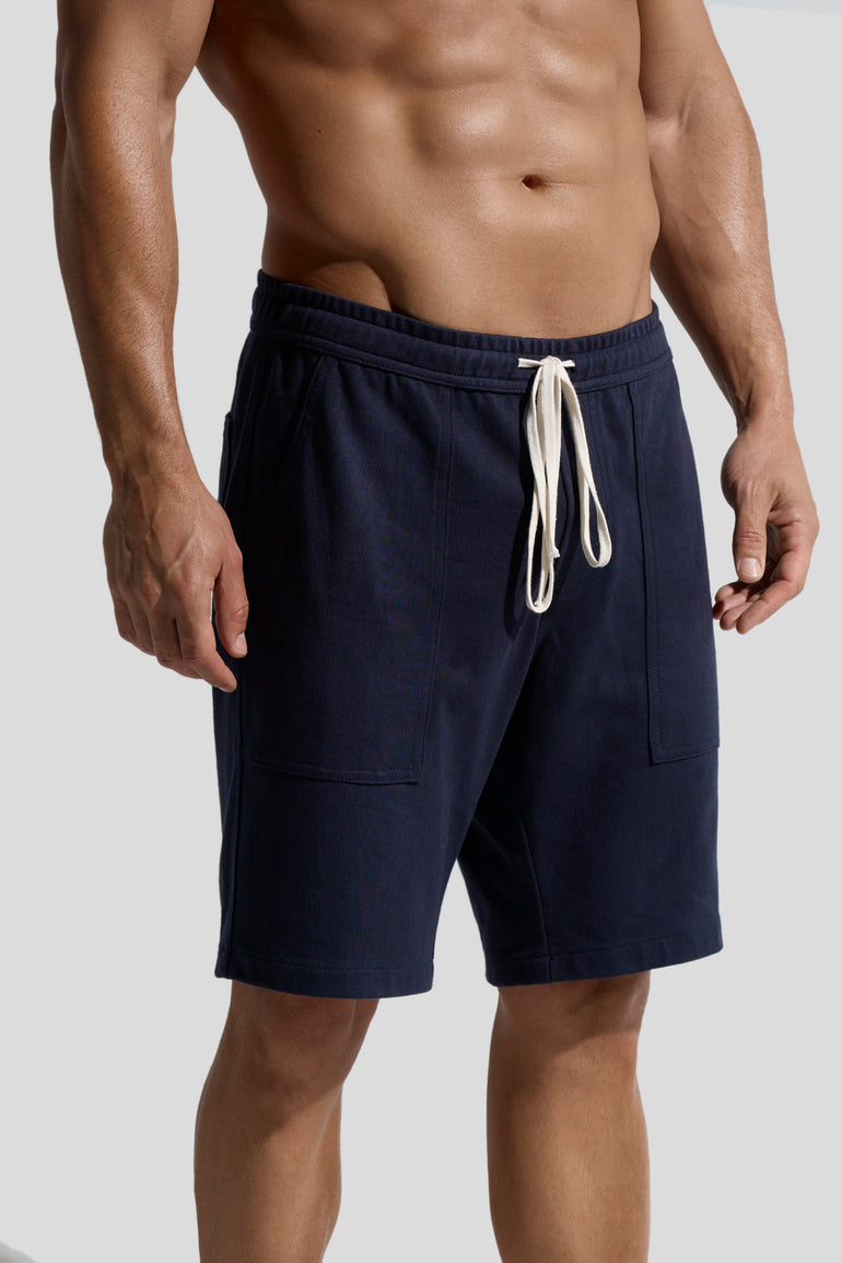 image of navy organic cotton shorts worn by male model side view by bas bains