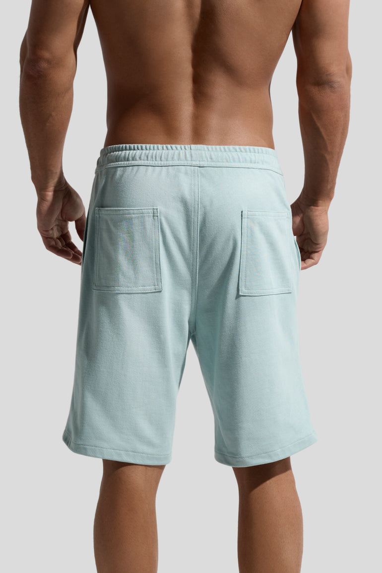 image of mint green organic cotton shorts back view worn by male model by bas bains