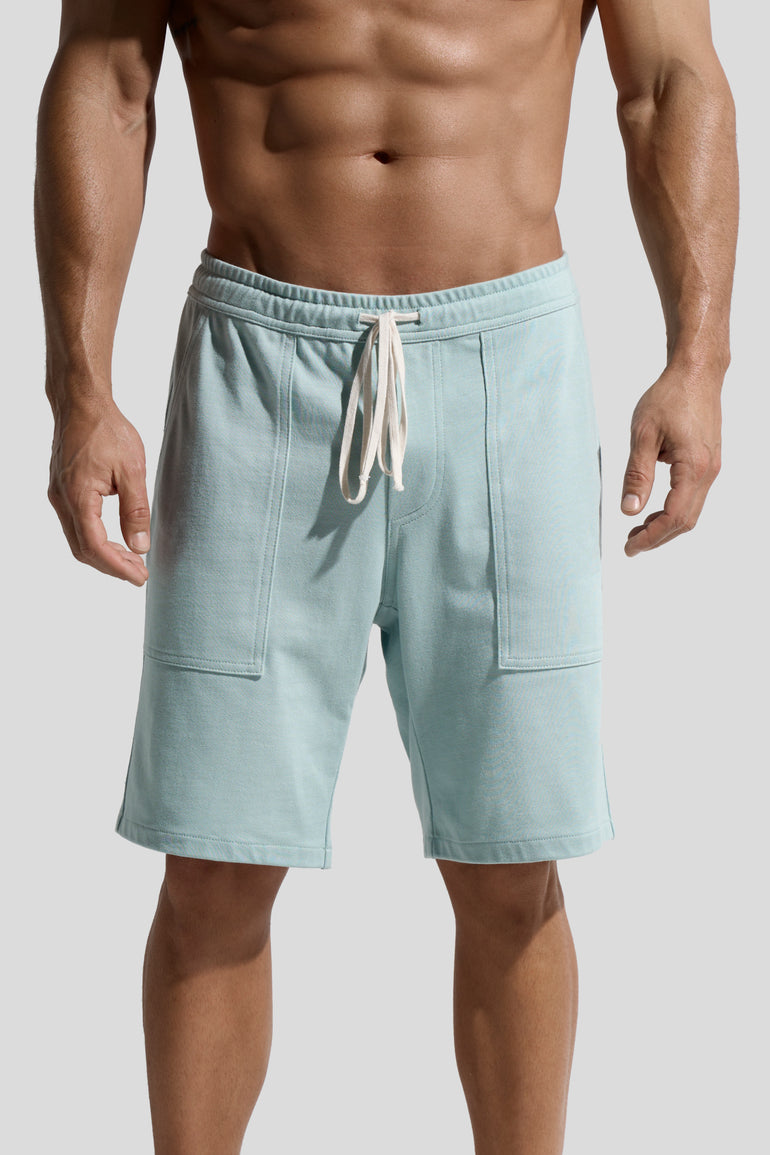 image of mint green organic cotton shorts front worn on male model by bas bains