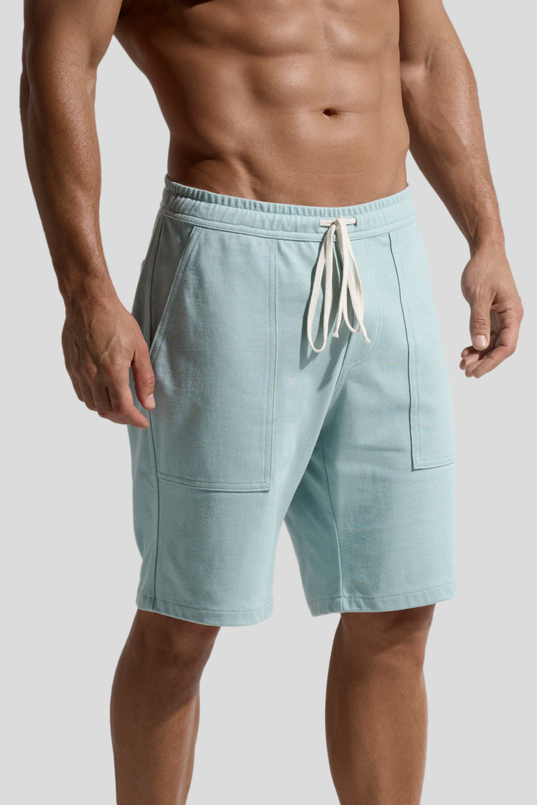 image of mint green organic cotton shorts side view worn by male model  by bas bains