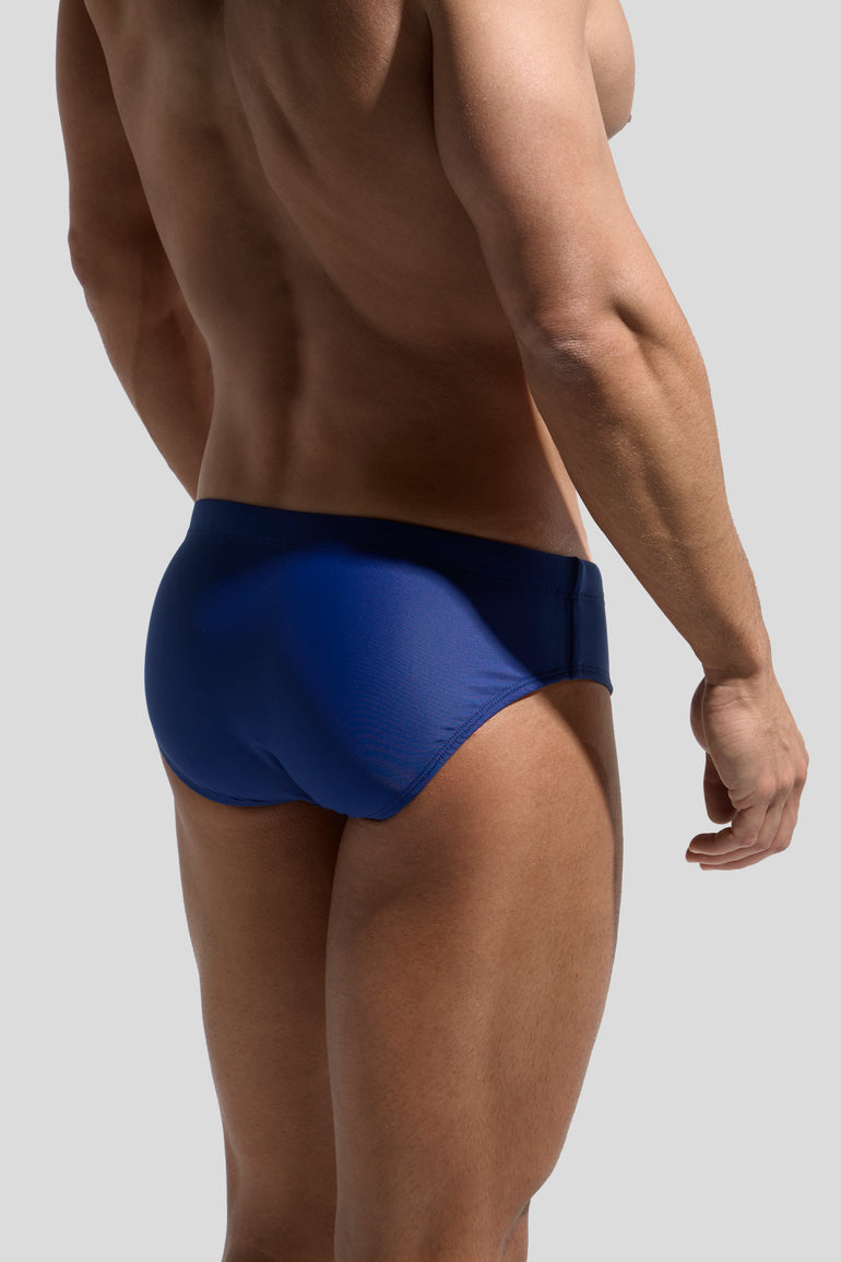 image of swimwear slip in marino blue back view on model by Bas Bains