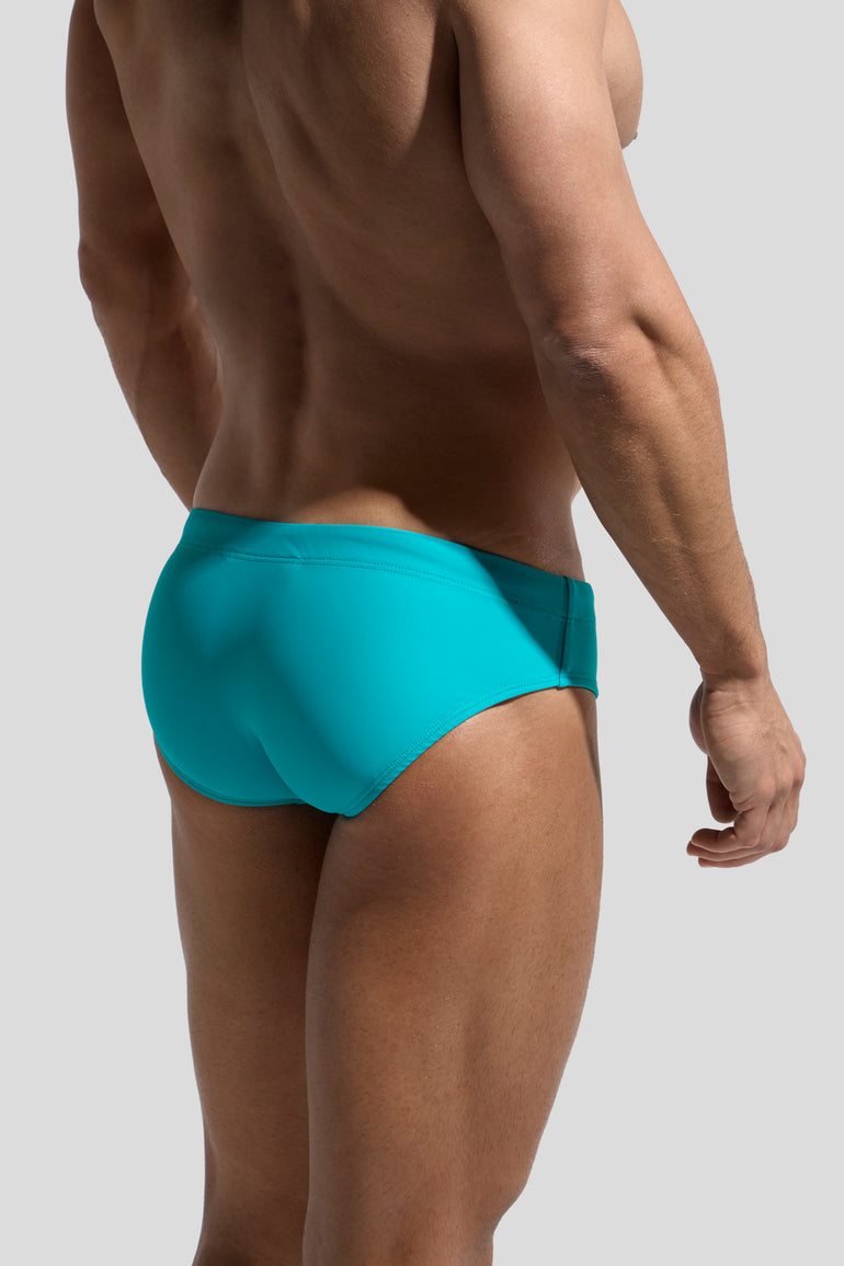 image of swimwear slip in menta green back view on male model by Bas Bains