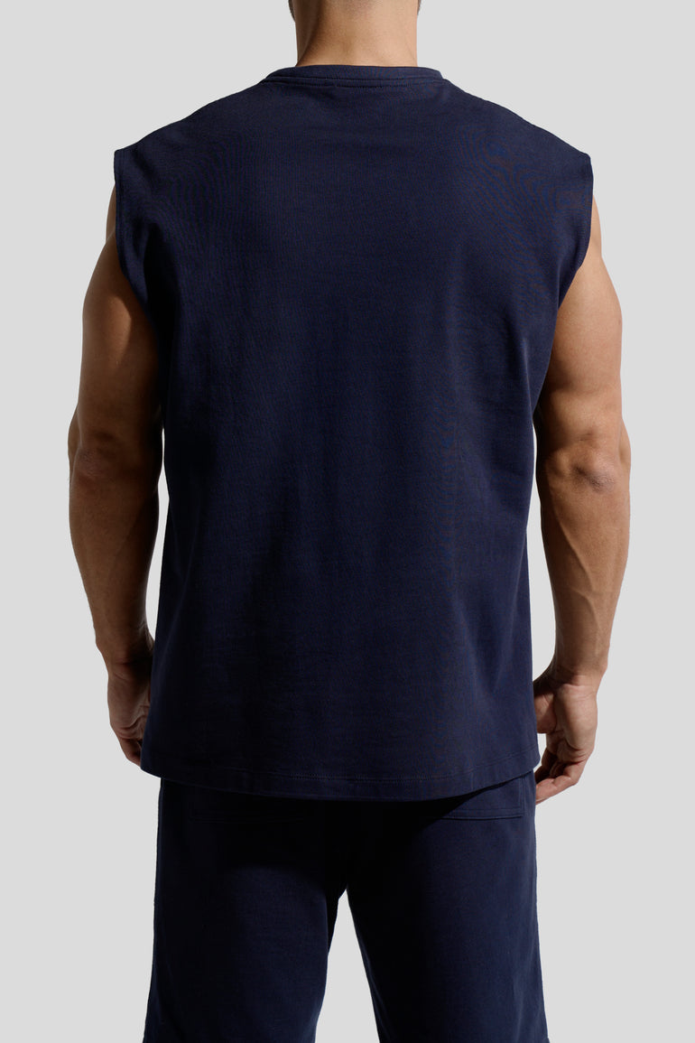 image of organic cotton tank top in Marino blue back view on male model by Bas Bains