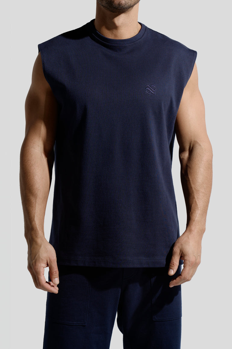 image of organic cotton tank top in Marino blue front view on male model by Bas Bains