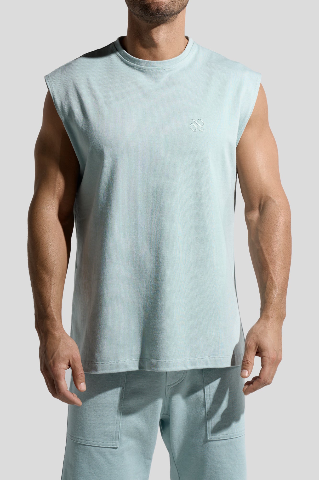 image of organic cotton tank top in Menta green front view on male model by Bas Bains