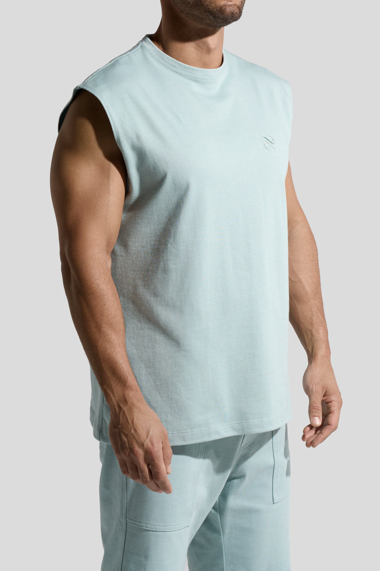 image of organic cotton tank top in Menta green side view on male model by Bas Bains