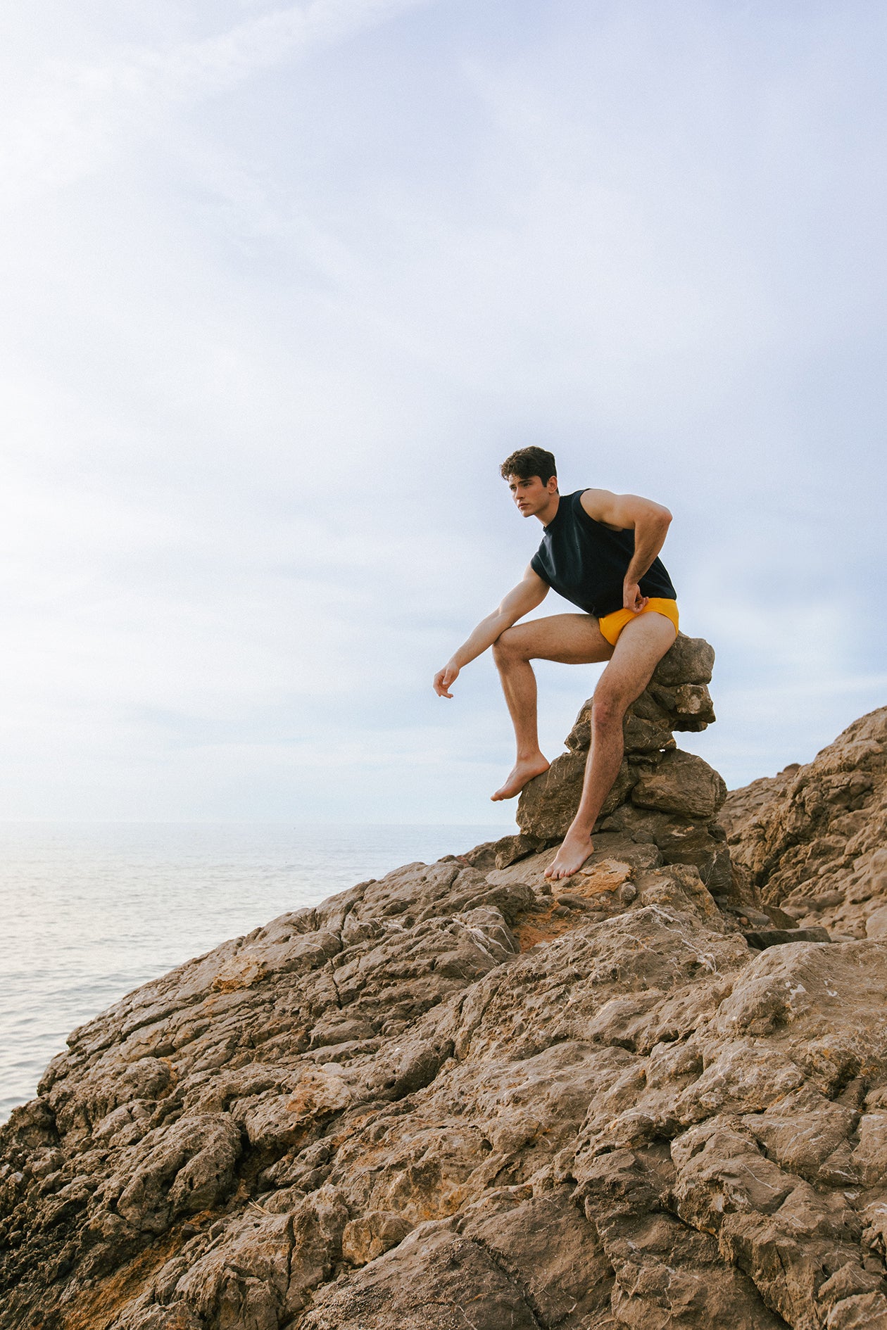 Dani Garcia on rocky beach wearing mandarin elia slip and marino pol tank by Bas Bains